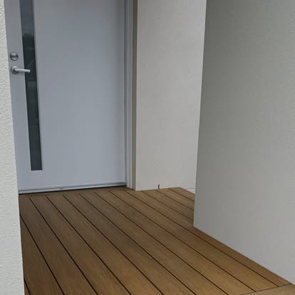 Composite timber-look decking laid at a front entry doorway